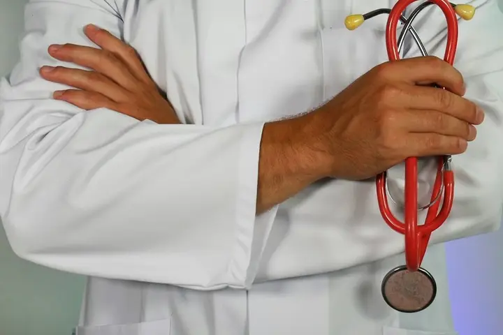 Doctor in a white coat holding a stethoscope